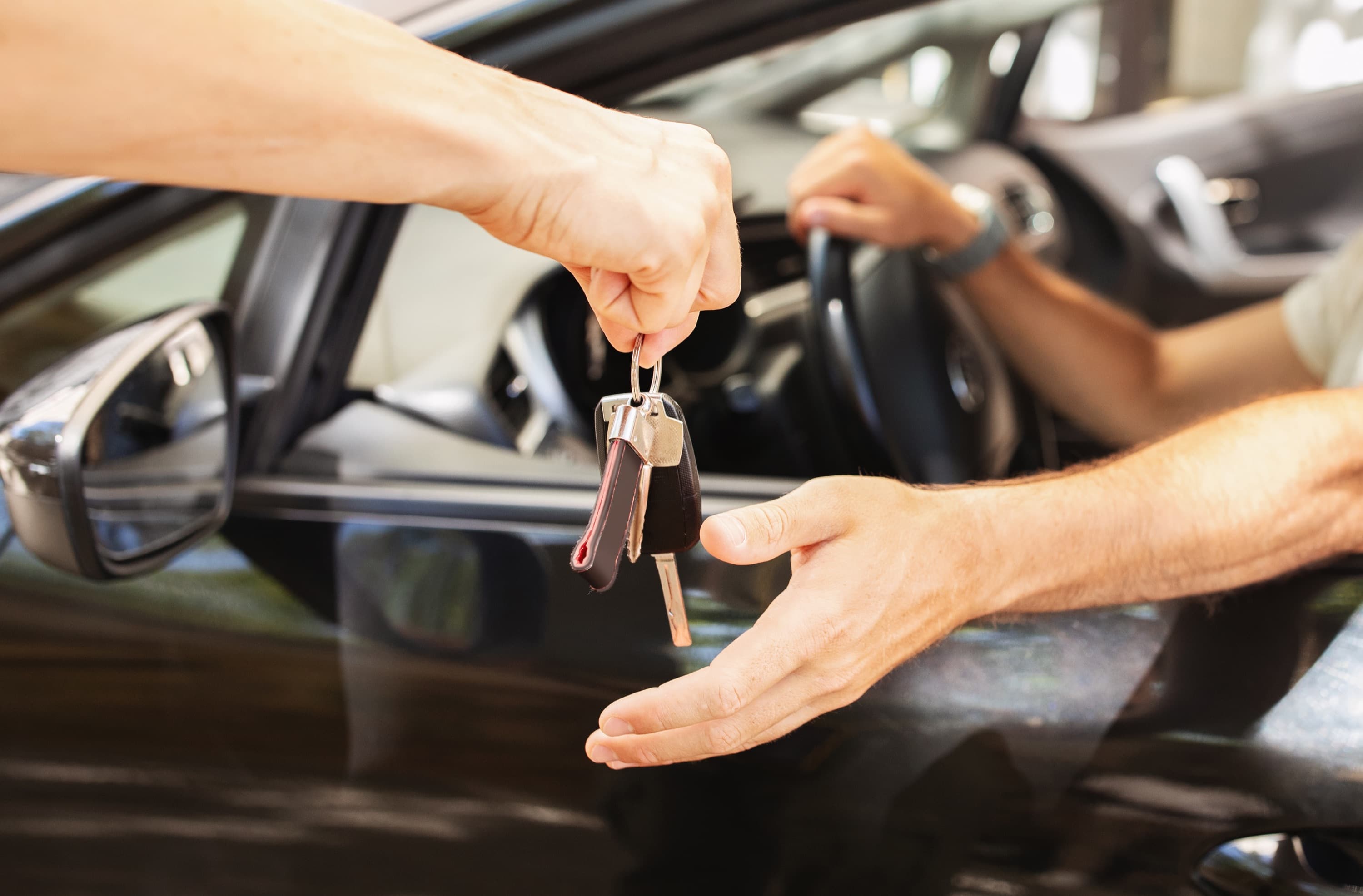 A customer handing over a car key