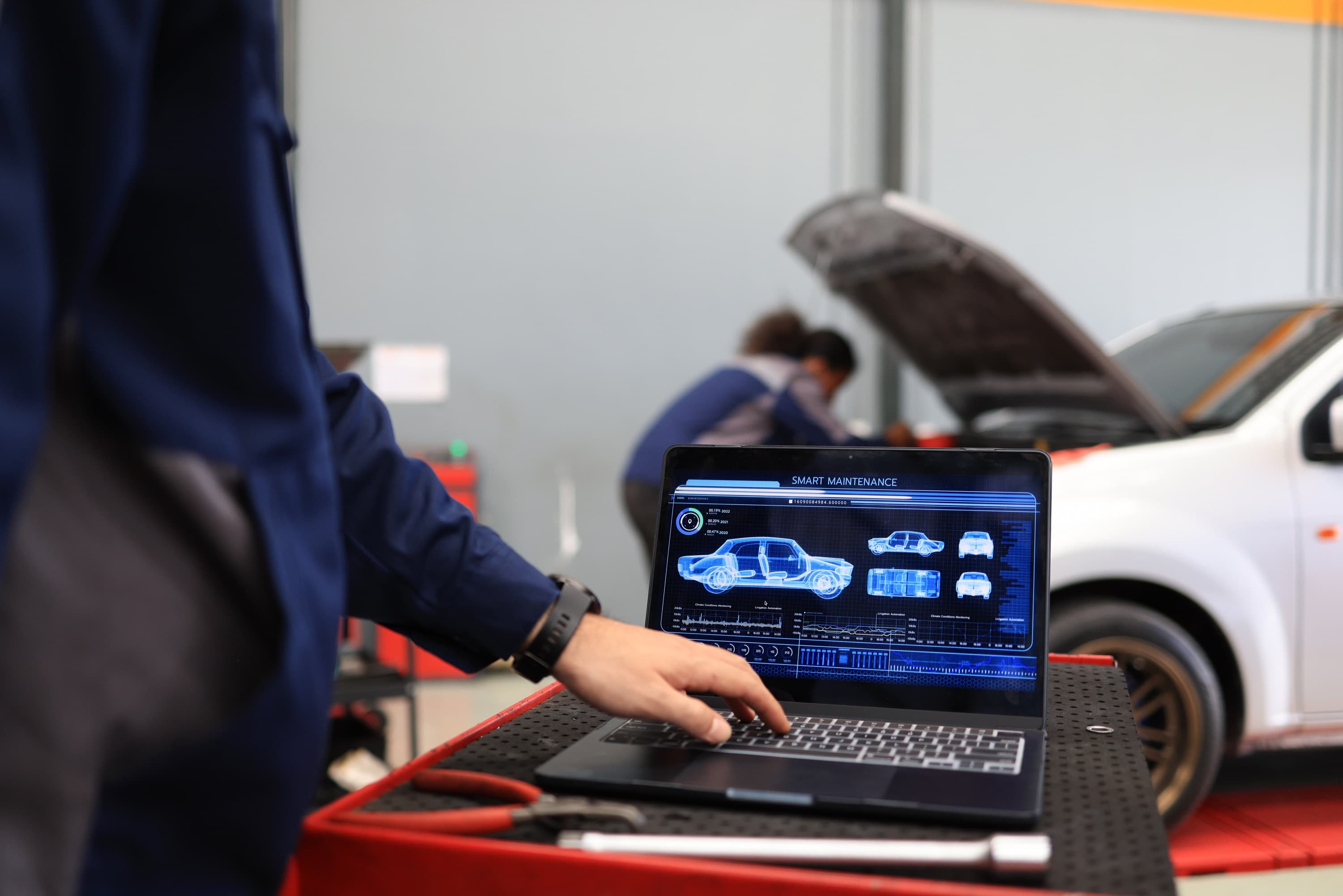 An ASE-certified automotive technician running diagnostics in the Handled shop